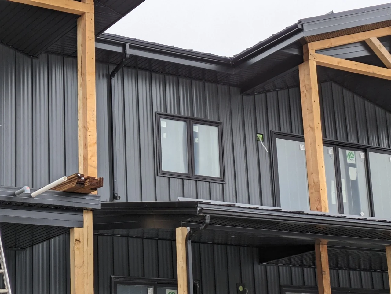 Dark eavestrough at several roof edges on a metal-sided home