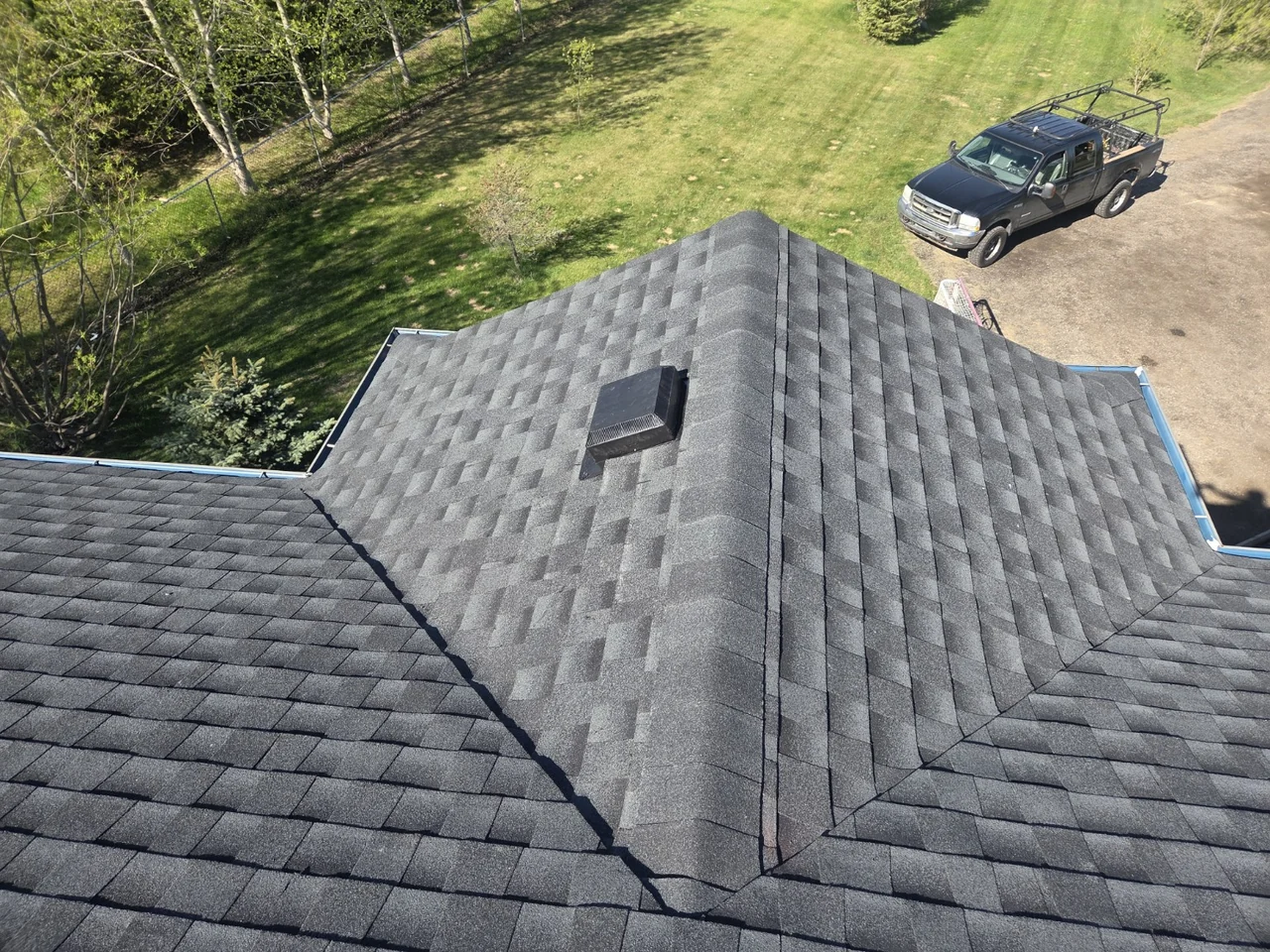 Completed grey Timberline HDZ shingle roof with ridge, valley and roof vent