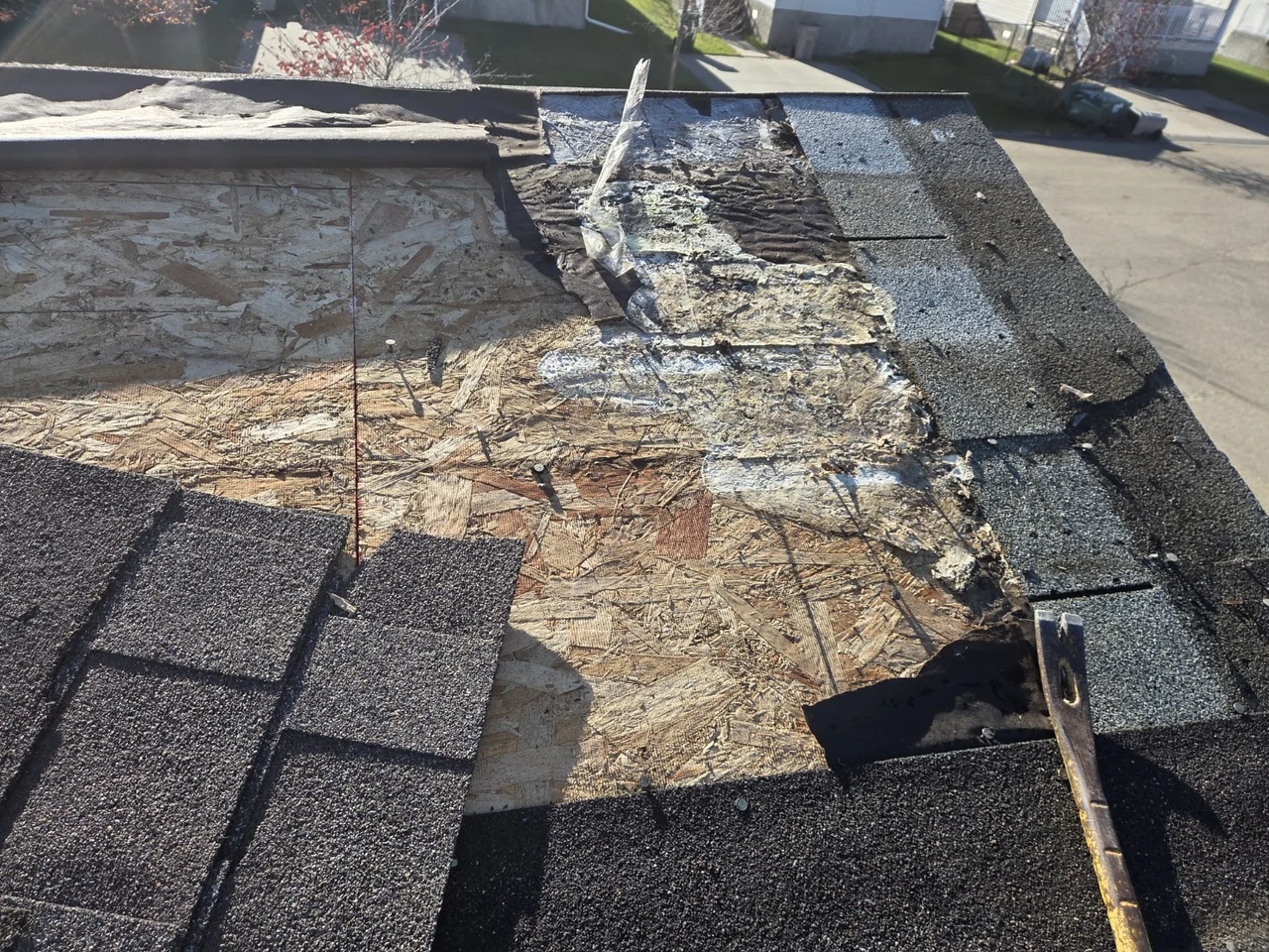Roofing opened during repair to show exposed decking and deteriorated material