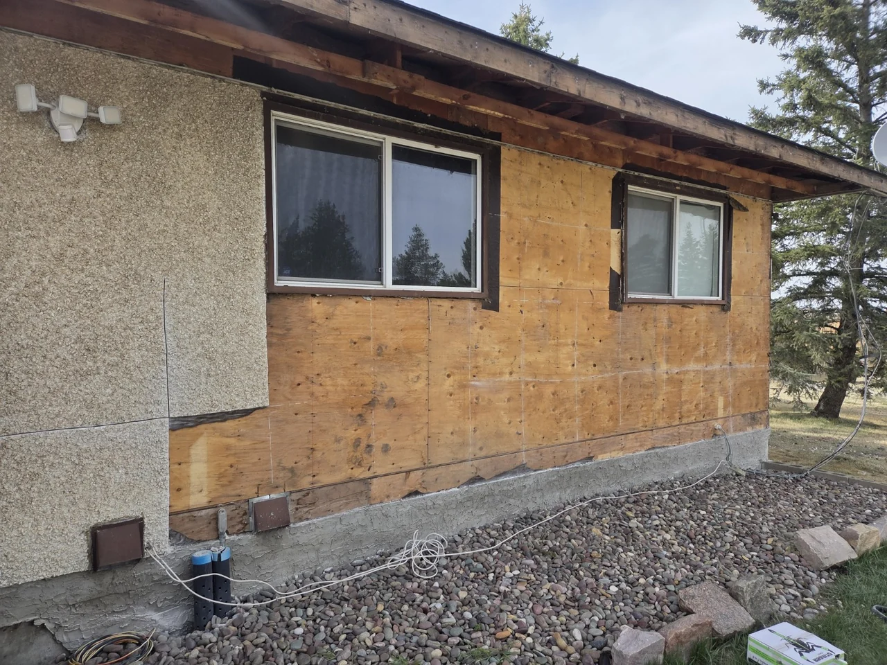 Existing cladding removed to expose the wall during the stucco renovation