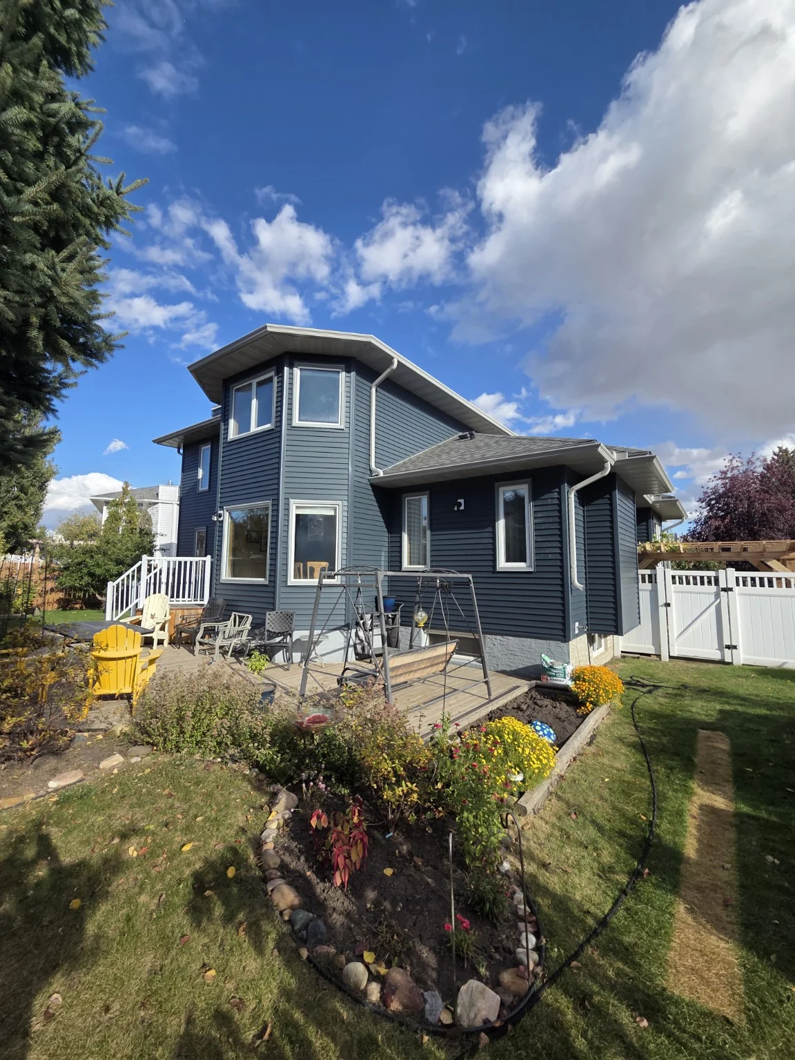 Blue vinyl siding and white trim on a Front-Line home renovation
