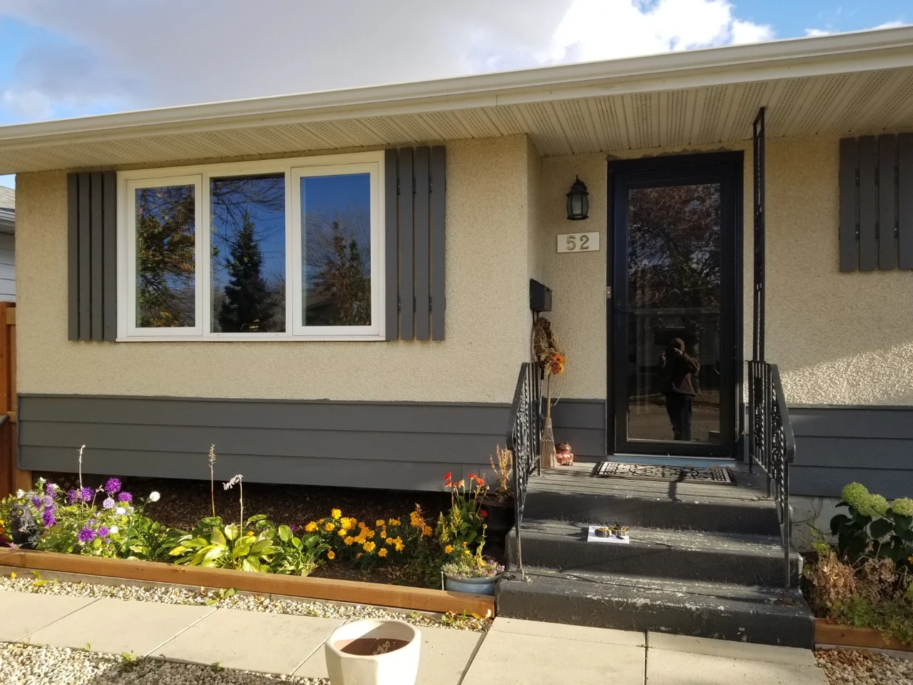 Original stucco at the front entrance before the insulated vinyl and capping renovation
